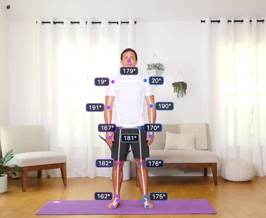 A person standing front-on with arms by their sides, with the tracked skeleton and joint angles drawn over the video.